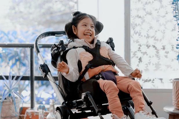 child with spina bifida in wheelchair
