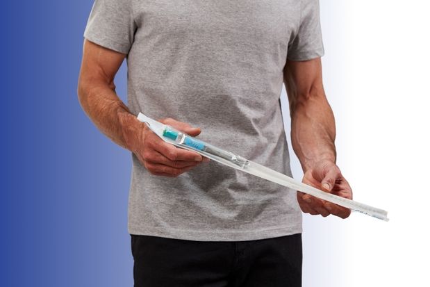 man holding gentlecath glide catheter