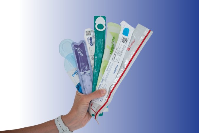 hand holding a variety of intermittent catheter options
